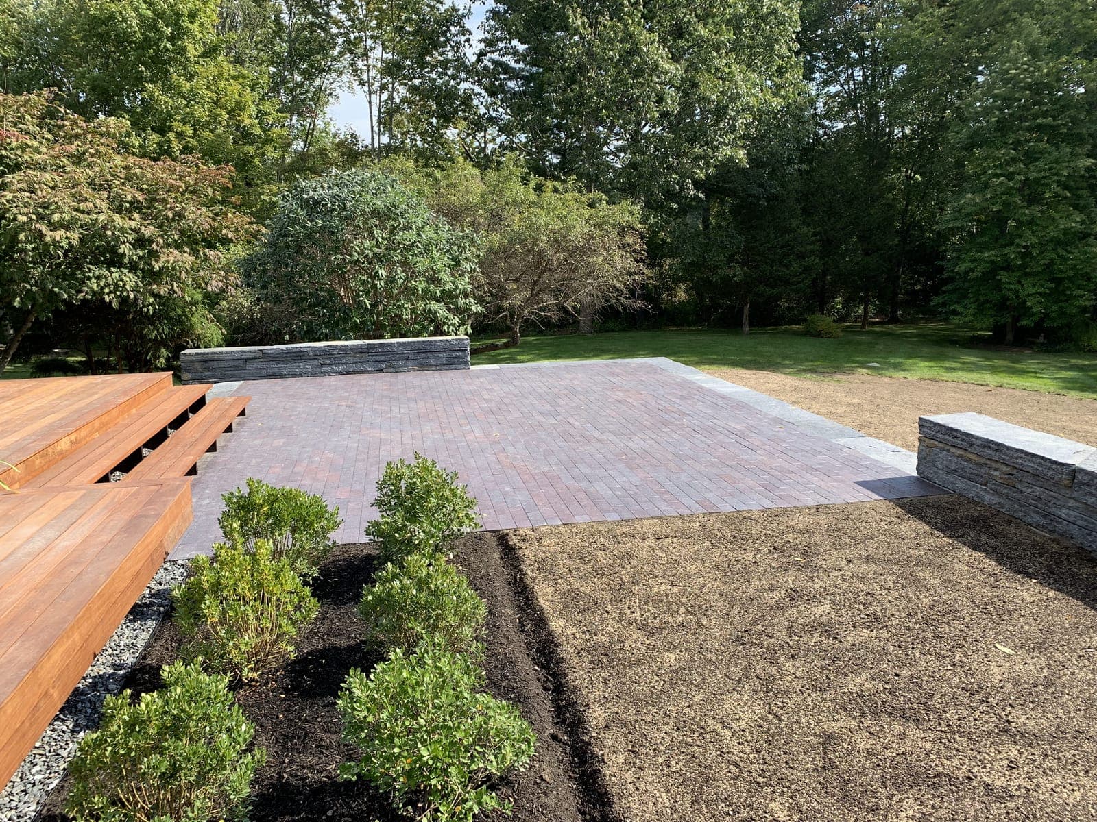 Stone patio, steps, and fieldstone wall in Weston, MA
